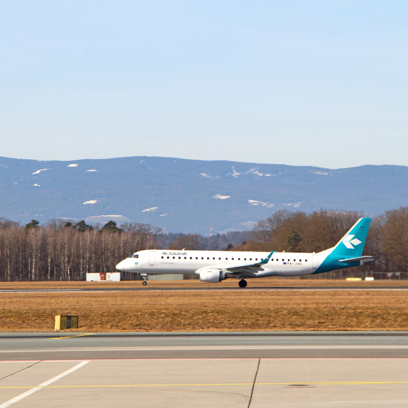 Air Dolomiti Ebmraer taking off.