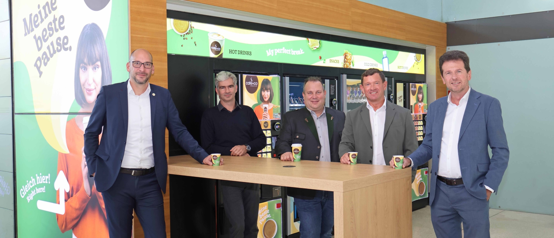 Group picture at the table in front of vending machines