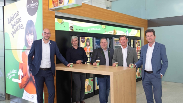 Group picture at the table in front of vending machines