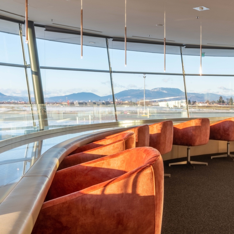 Orange couch chairs in front of the window